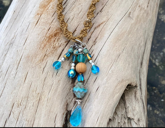 Boho Braided necklace, with Blue Dangle,  ocean beads, on  a piece of driftwood