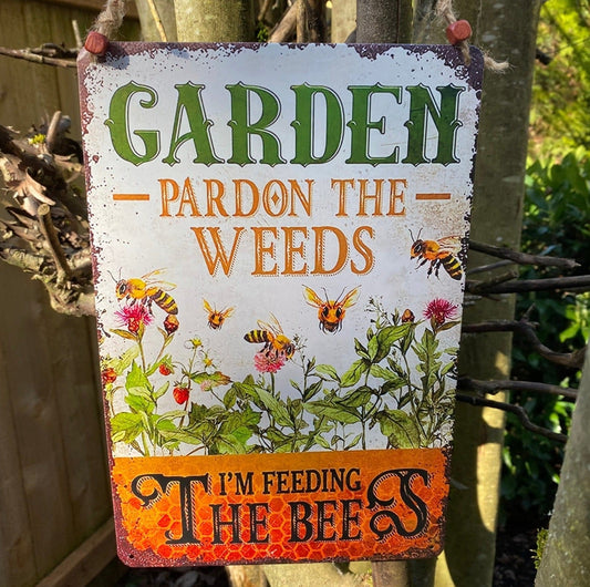 tin sign hanging on a tree Garden Pardon the weeds im feeding the bees, garden sign, bee lovewrs